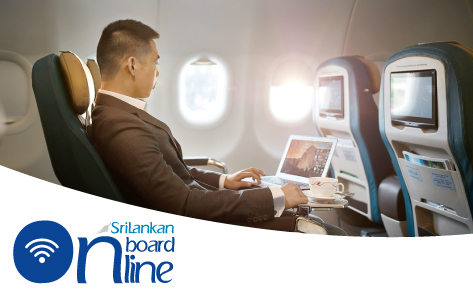 A female passenger in business attire is using a laptop connected to inflight wifi